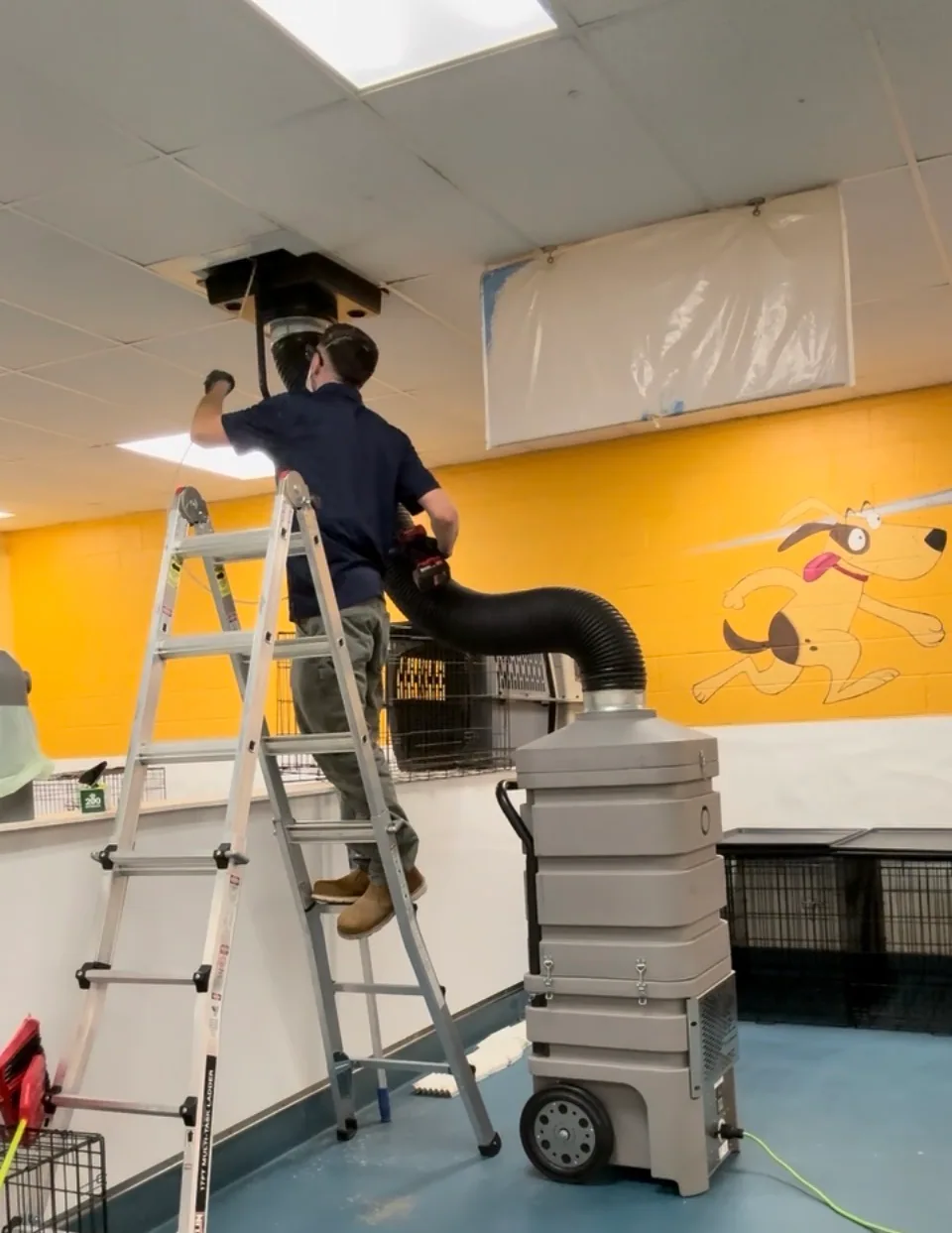 Air Duct Cleaners technician working at a ceiling duct